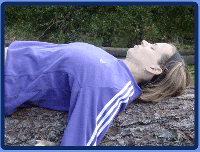 student reclining on redwood